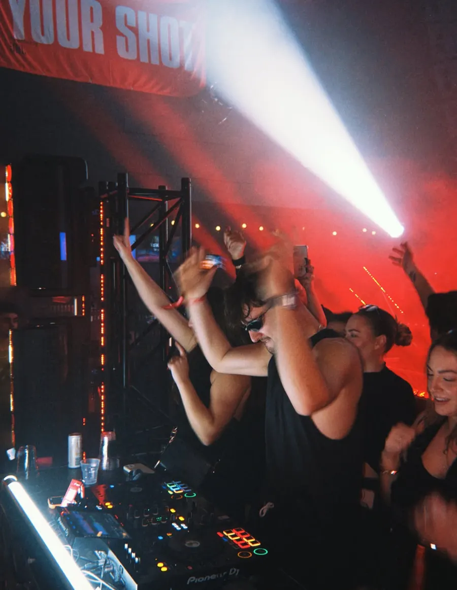 Crowd hands up under the lights
